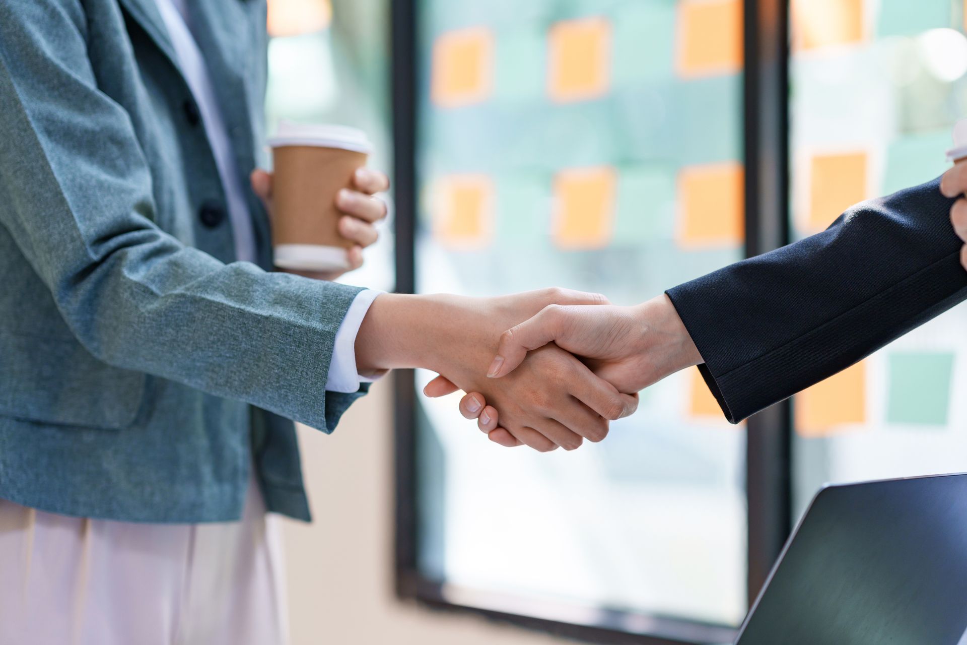 Business People standing, congratulating shaking hands confirming the agreement of doing business together. and propose new projects.
